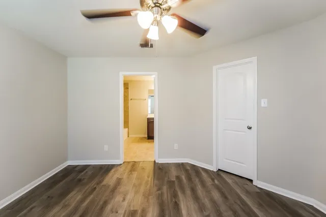 a view of an empty room and wooden floor