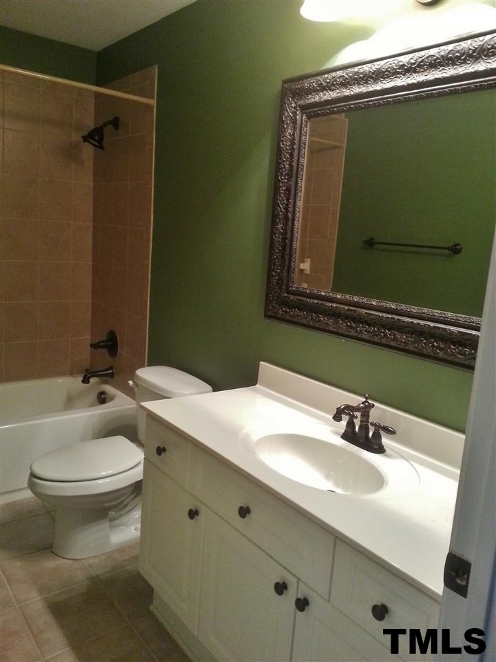 7203 Newport Avenue Raleigh, NC 27613 - Photo 12 of 24 a bathroom with a sink and a mirror