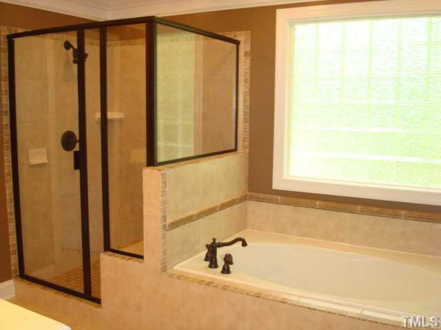 7203 Newport Avenue Raleigh, NC 27613 - Photo 18 of 24 a bathroom with a shower and a bathtub