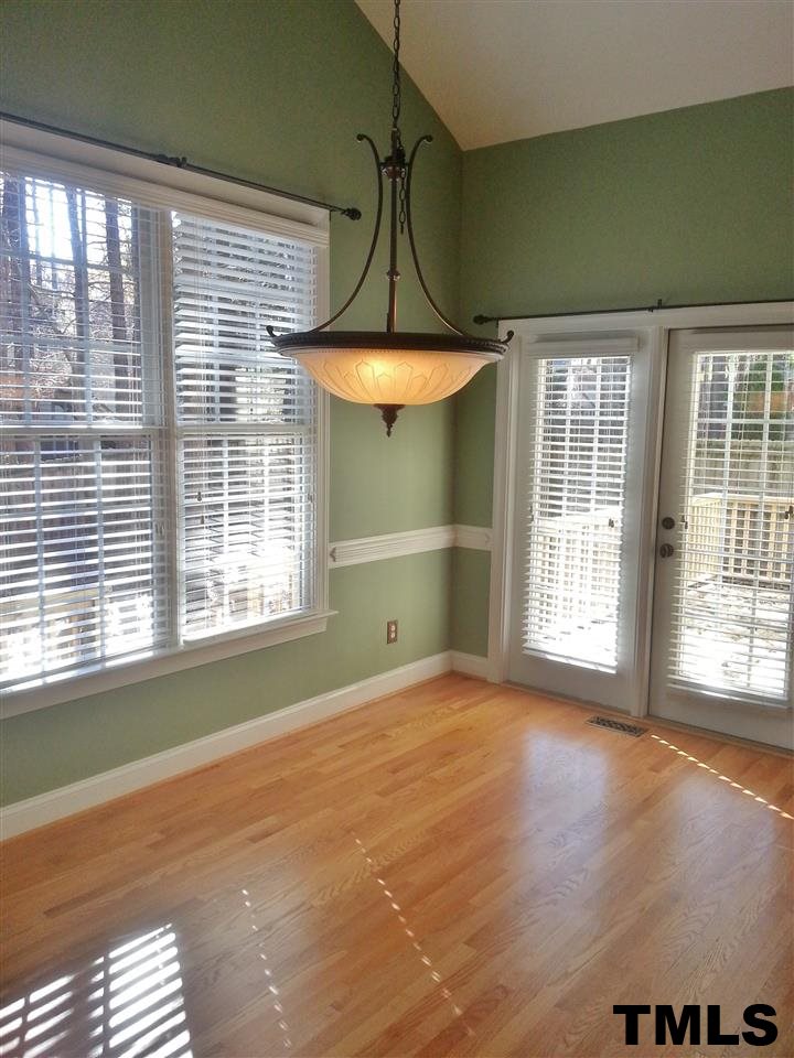 7203 Newport Avenue Raleigh, NC 27613 - Photo 7 of 24 an empty room with a window and chandelier