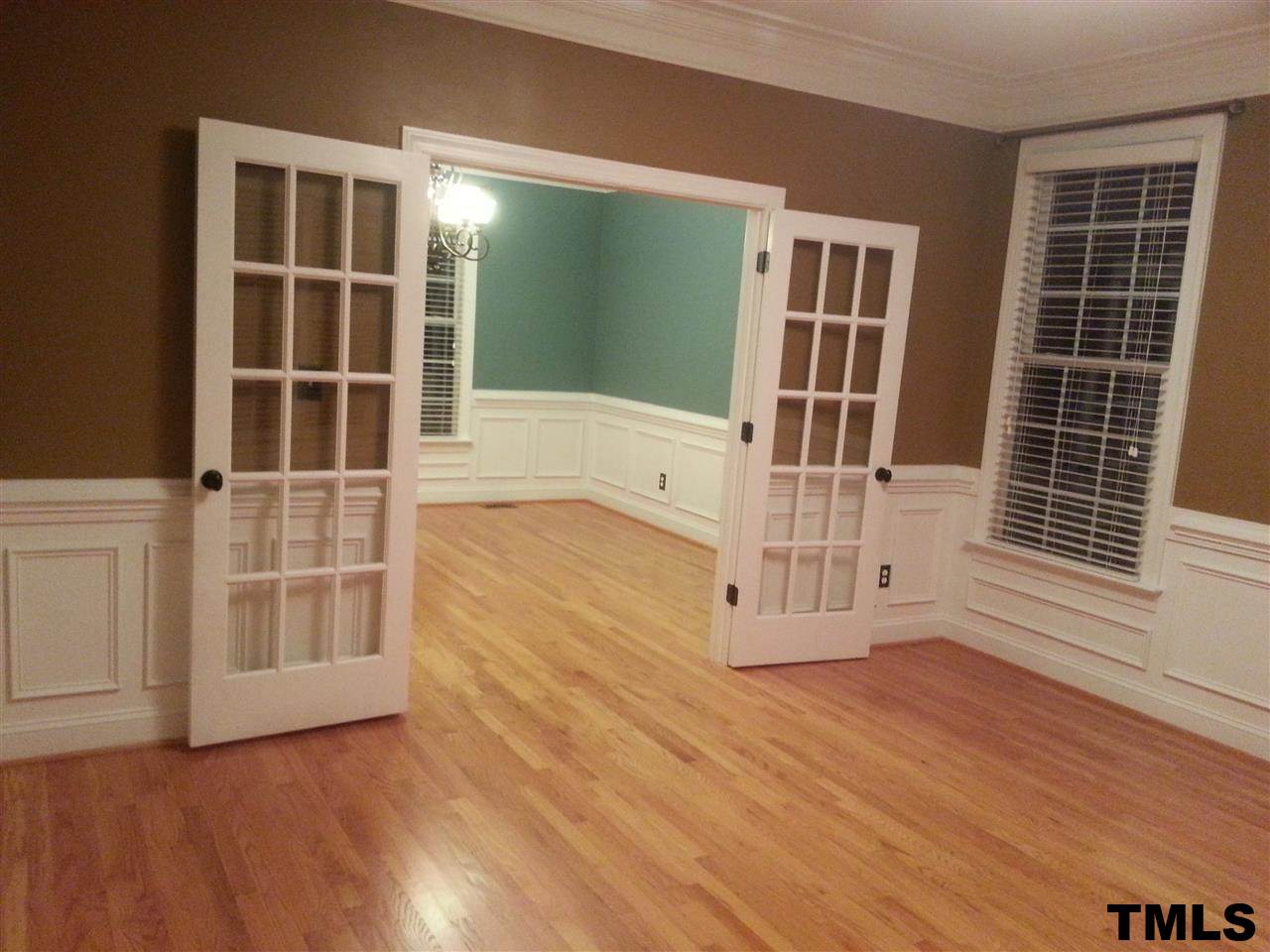 7203 Newport Avenue Raleigh, NC 27613 - Photo 24 of 24 an empty room with wooden floor and windows