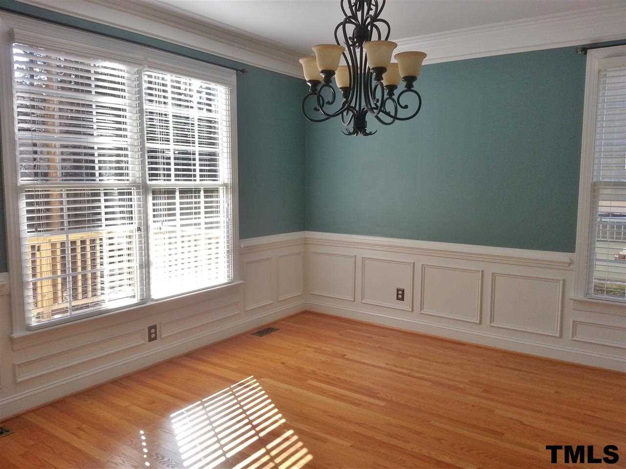 7203 Newport Avenue Raleigh, NC 27613 - Photo 9 of 24 a view of empty room with wooden floor and fan