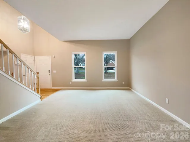 a view of an empty room with windows