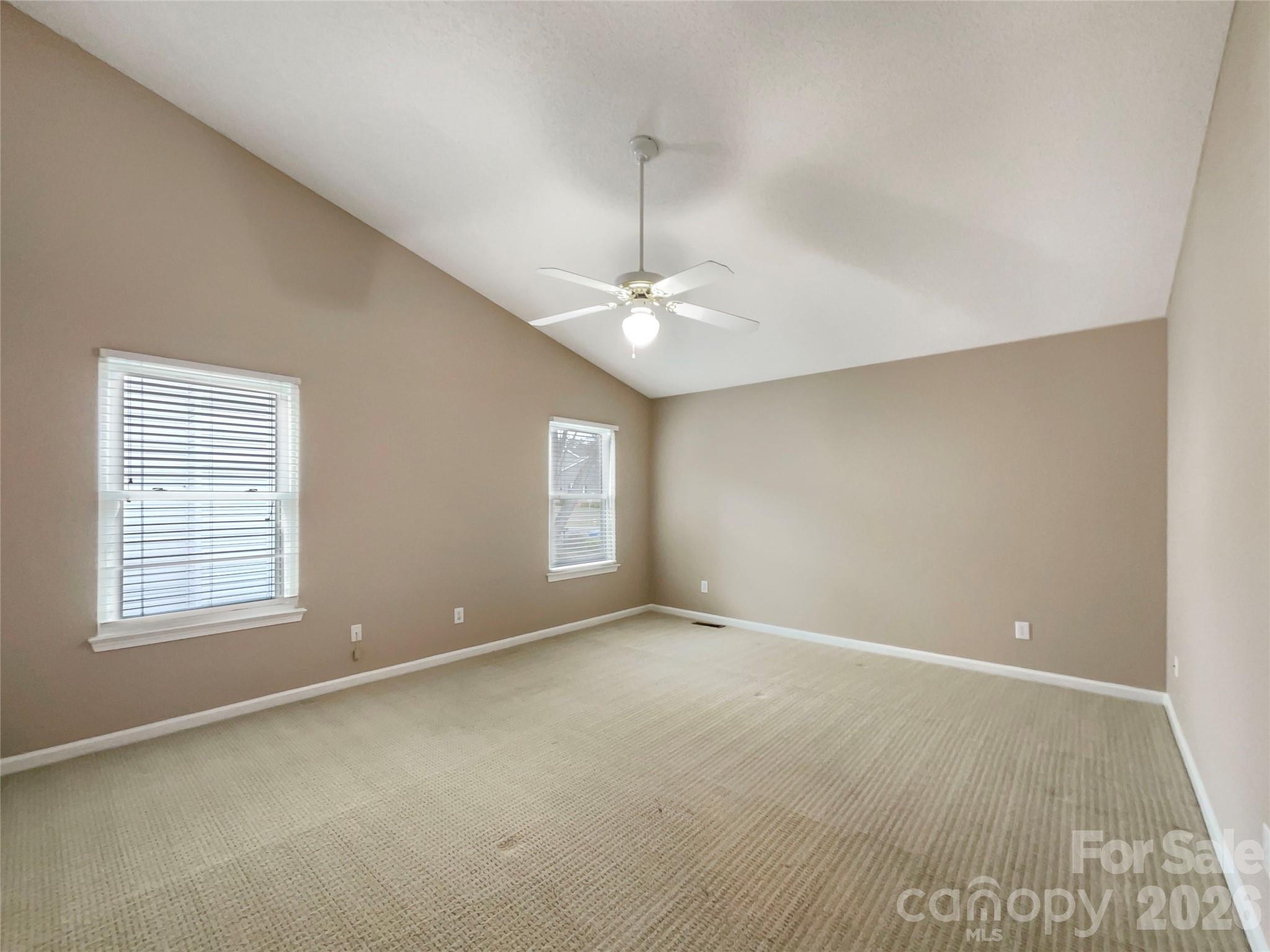 231 Fox Hollow Road Mooresville, NC 28117 - Photo 4 of 20 an empty room with windows and chandelier fan