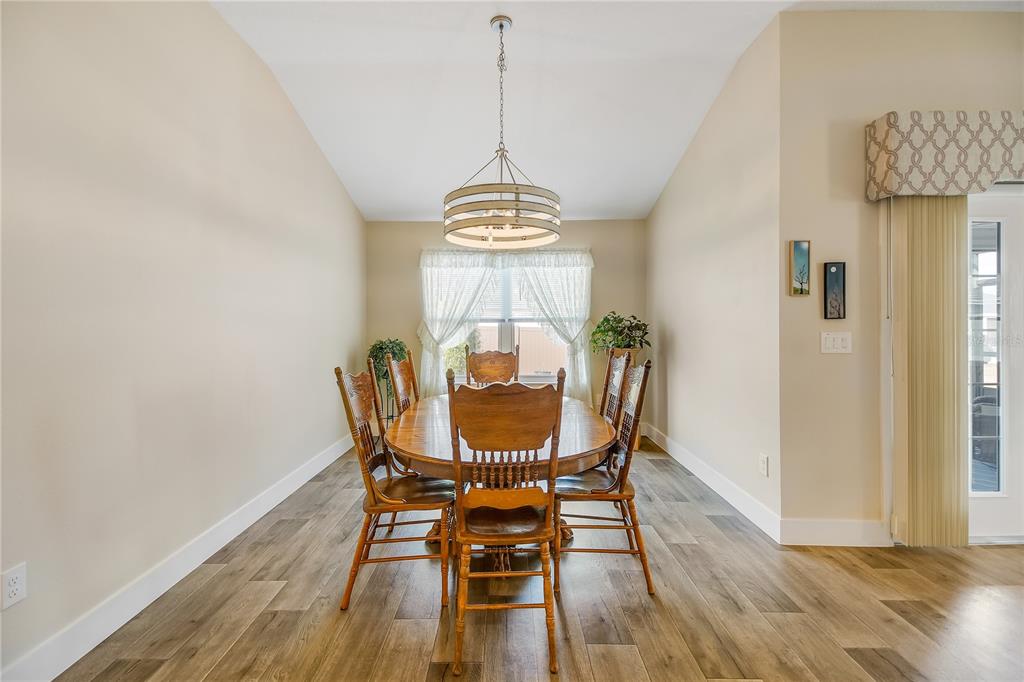 3323 Rohan Road Oxford, FL 34484 - Photo 14 of 46 a view of a dining room with furniture window and wooden floor