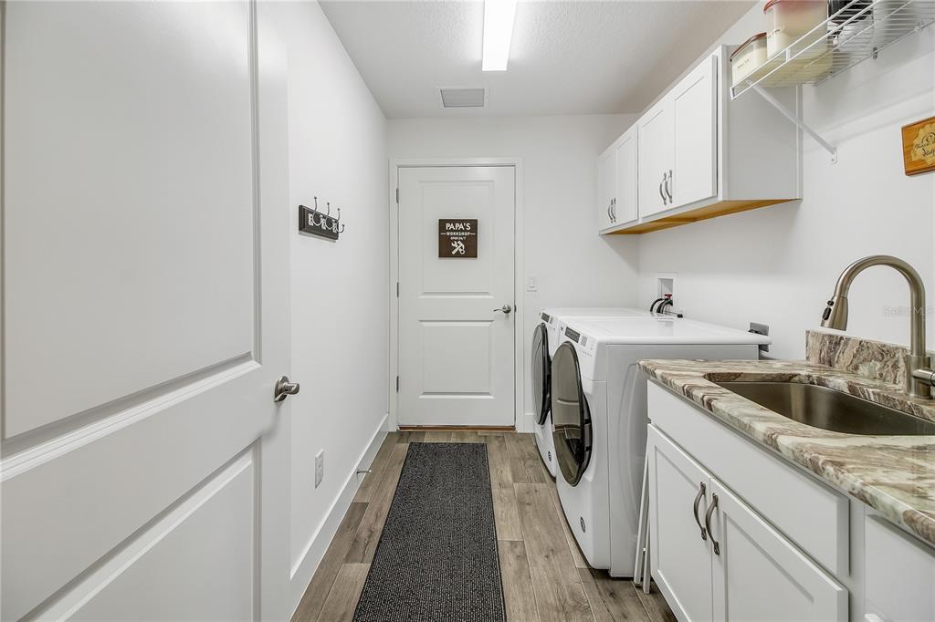 3323 Rohan Road Oxford, FL 34484 - Photo 19 of 46 a storage room with a sink and washer
