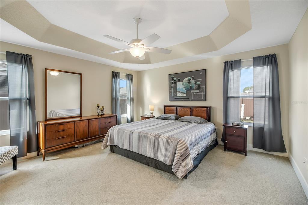 3323 Rohan Road Oxford, FL 34484 - Photo 20 of 46 a bedroom with a bed and ceiling fan