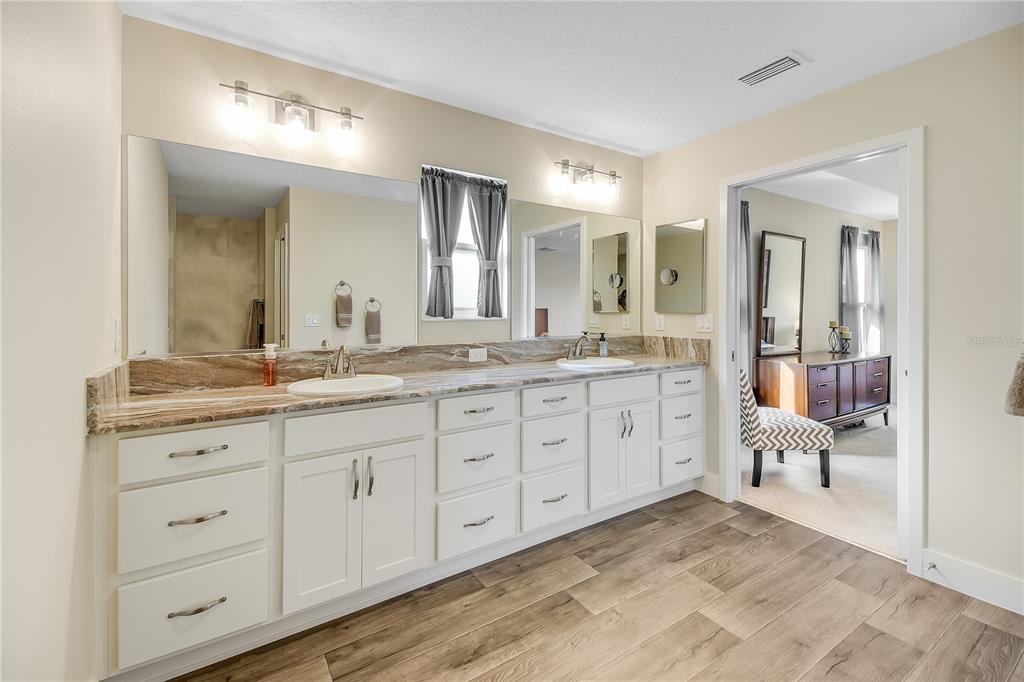 3323 Rohan Road Oxford, FL 34484 - Photo 27 of 46 a spacious bathroom with double sink and a mirror