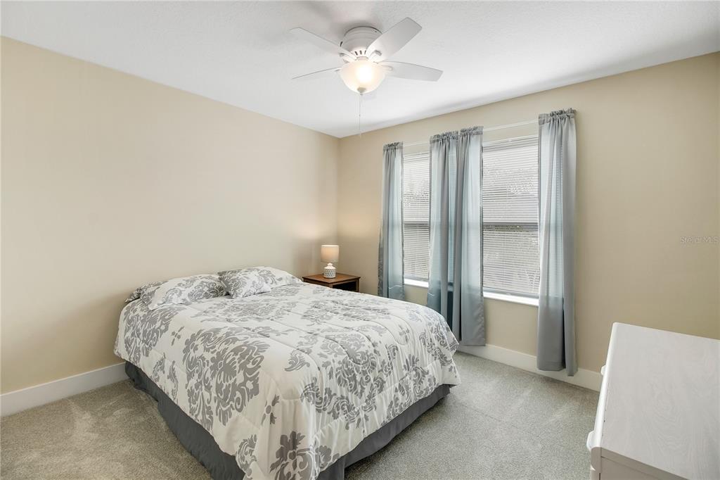 3323 Rohan Road Oxford, FL 34484 - Photo 37 of 46 a bedroom with a bed and a chandelier