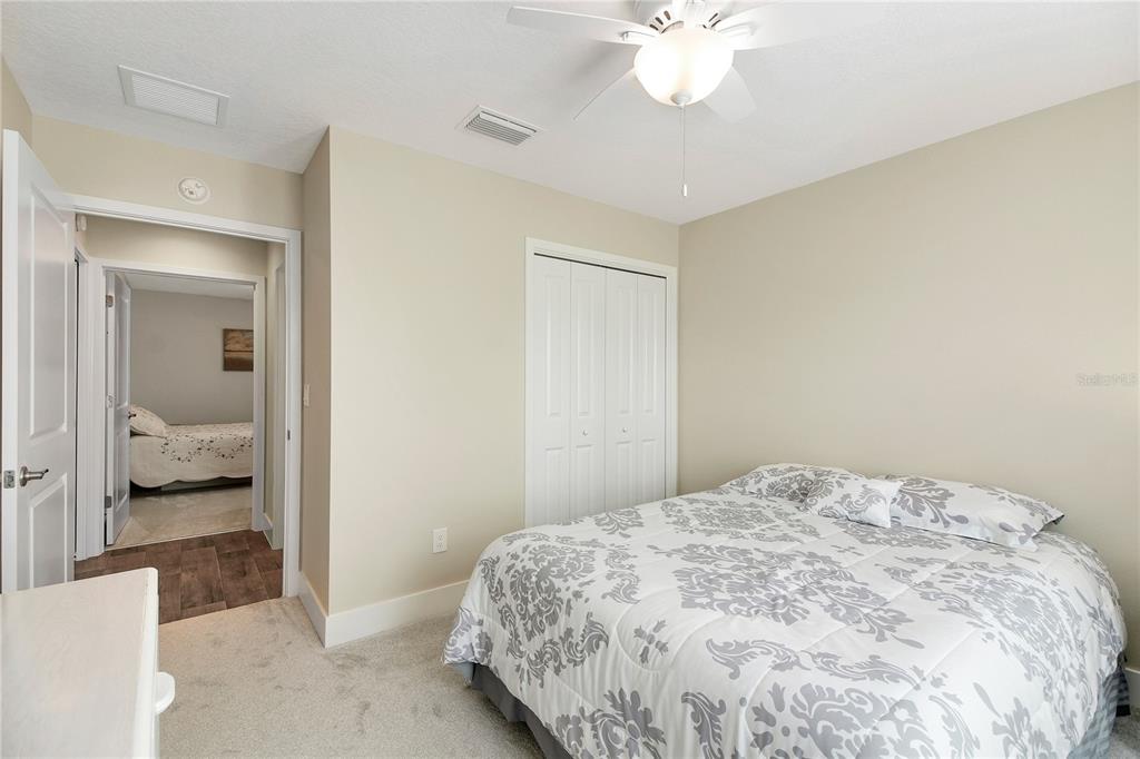 3323 Rohan Road Oxford, FL 34484 - Photo 38 of 46 a bedroom with a large bed and a chandelier