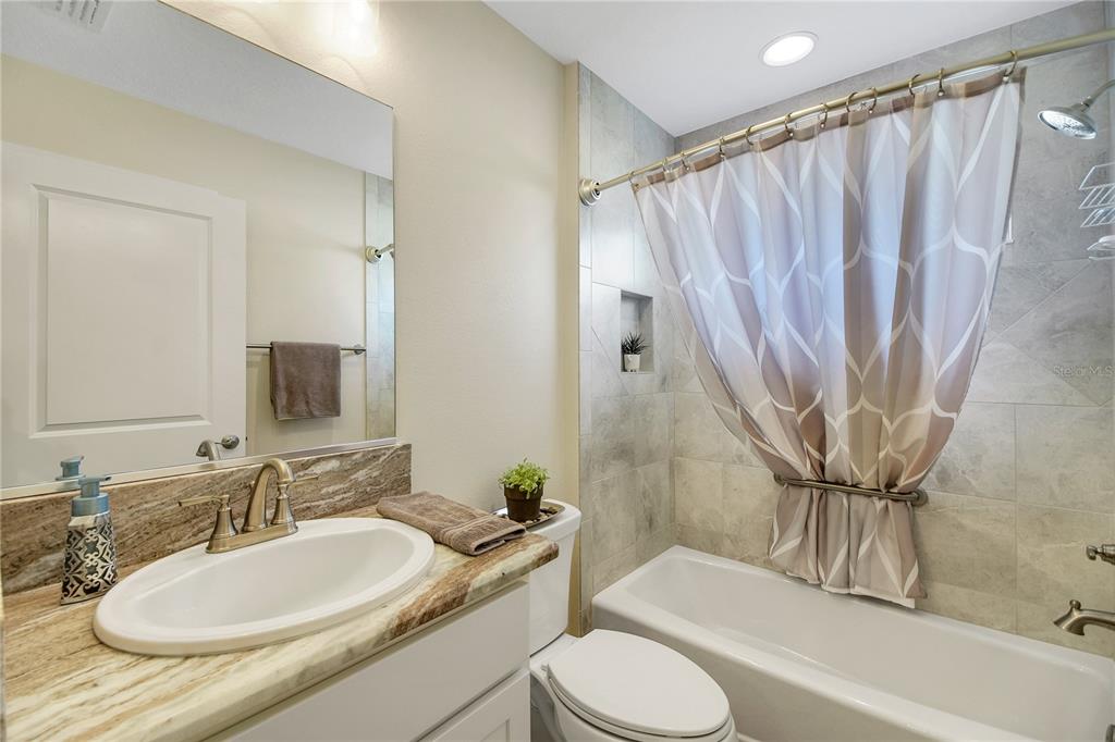 3323 Rohan Road Oxford, FL 34484 - Photo 39 of 46 a bathroom with a granite countertop sink toilet and shower