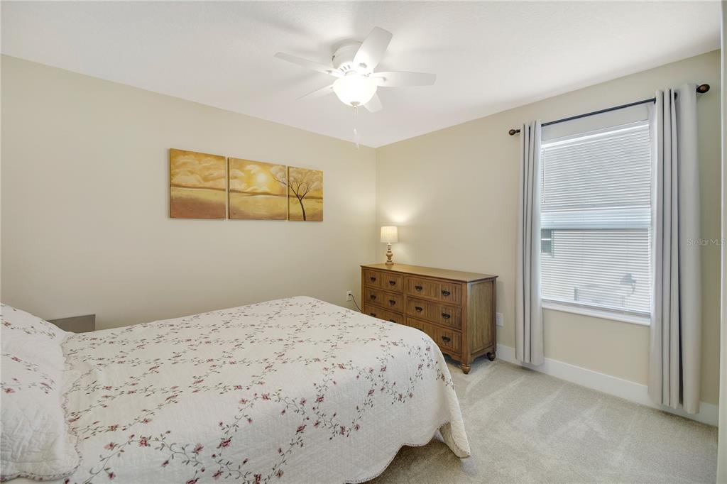 3323 Rohan Road Oxford, FL 34484 - Photo 41 of 46 a bedroom with a bed and a painting on the wall