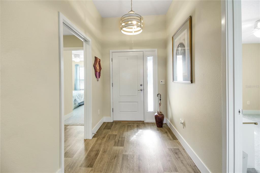 3323 Rohan Road Oxford, FL 34484 - Photo 6 of 46 a view of a hallway with wooden floor and staircase