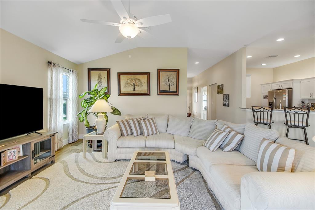 3323 Rohan Road Oxford, FL 34484 - Photo 8 of 46 a living room with furniture and a flat screen tv