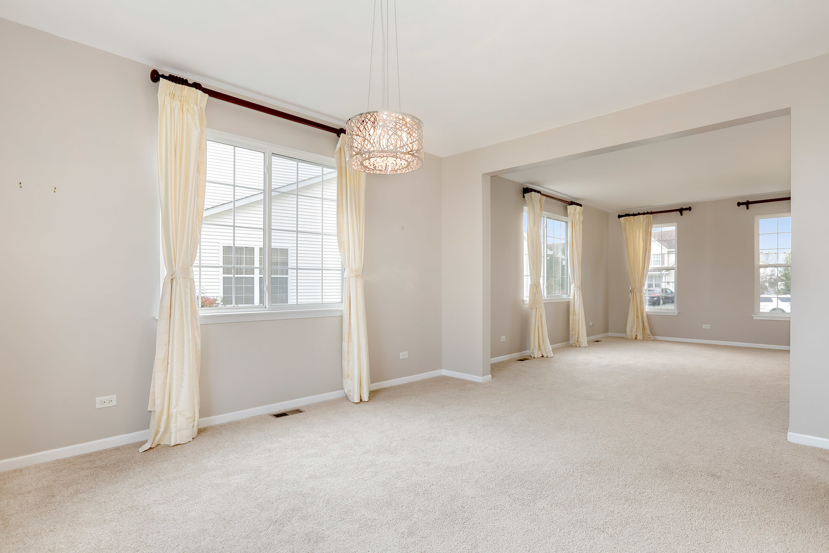 1786 Prairie Ridge Circle Lindenhurst, IL 60046 - Photo 8 of 34 an empty room with chandelier fan and windows