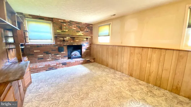 a view of livingroom with furniture and a fireplace