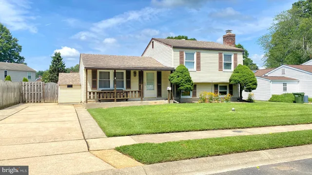 a view of a house with a garden and pathway