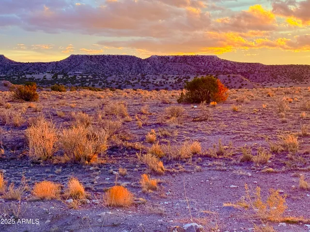 a view of mountain with sunset