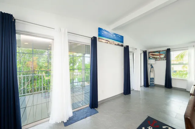a view of a room with window and wooden floor