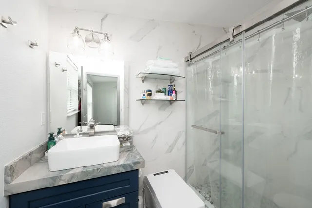a bathroom with a sink toilet and shower