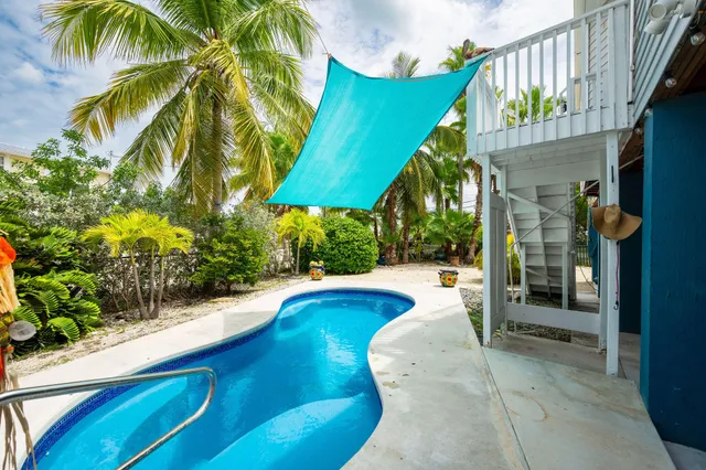 a swimming pool with outdoor seating and yard