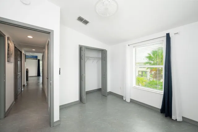 a view of empty room with closet and fan