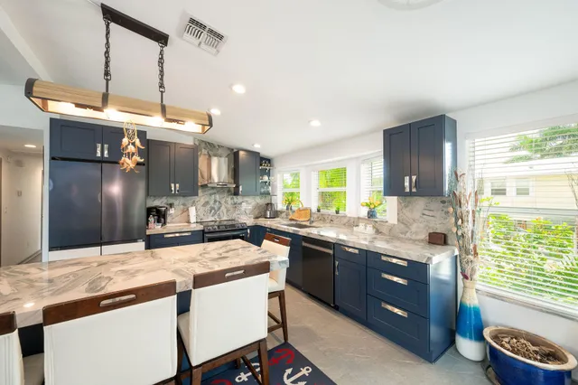 a kitchen with a sink stove and refrigerator