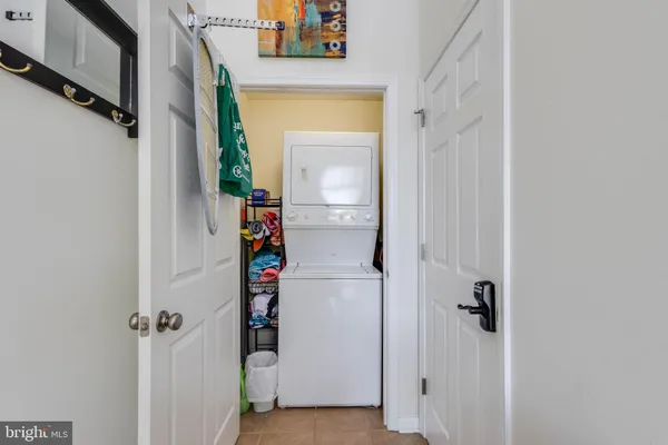 a view of a hallway with wooden floor and closet