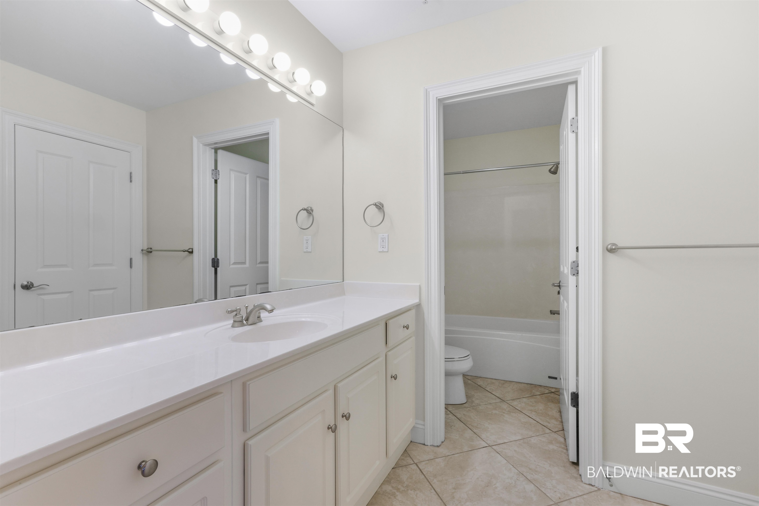 28250 Canal Road, Unit 106 Orange Beach, AL 36561 - Photo 26 of 50 Full bathroom with vanity, shower / tub combination, and light tile patterned flooring