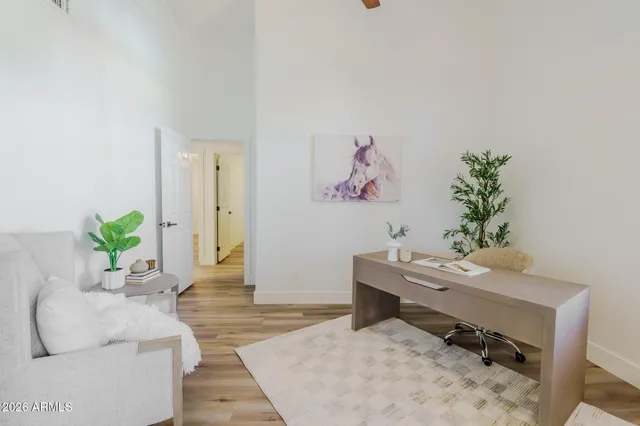 a living room with furniture and a potted plant