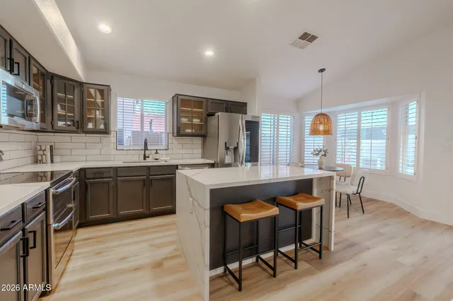 a kitchen with a sink cabinets and wooden floor