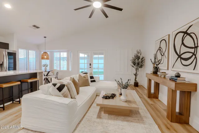 a living room with furniture and a chandelier