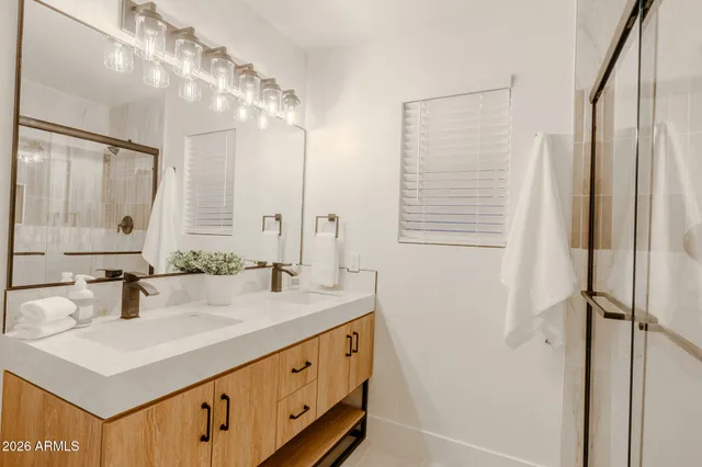 a bathroom with a sink double vanity and a mirror