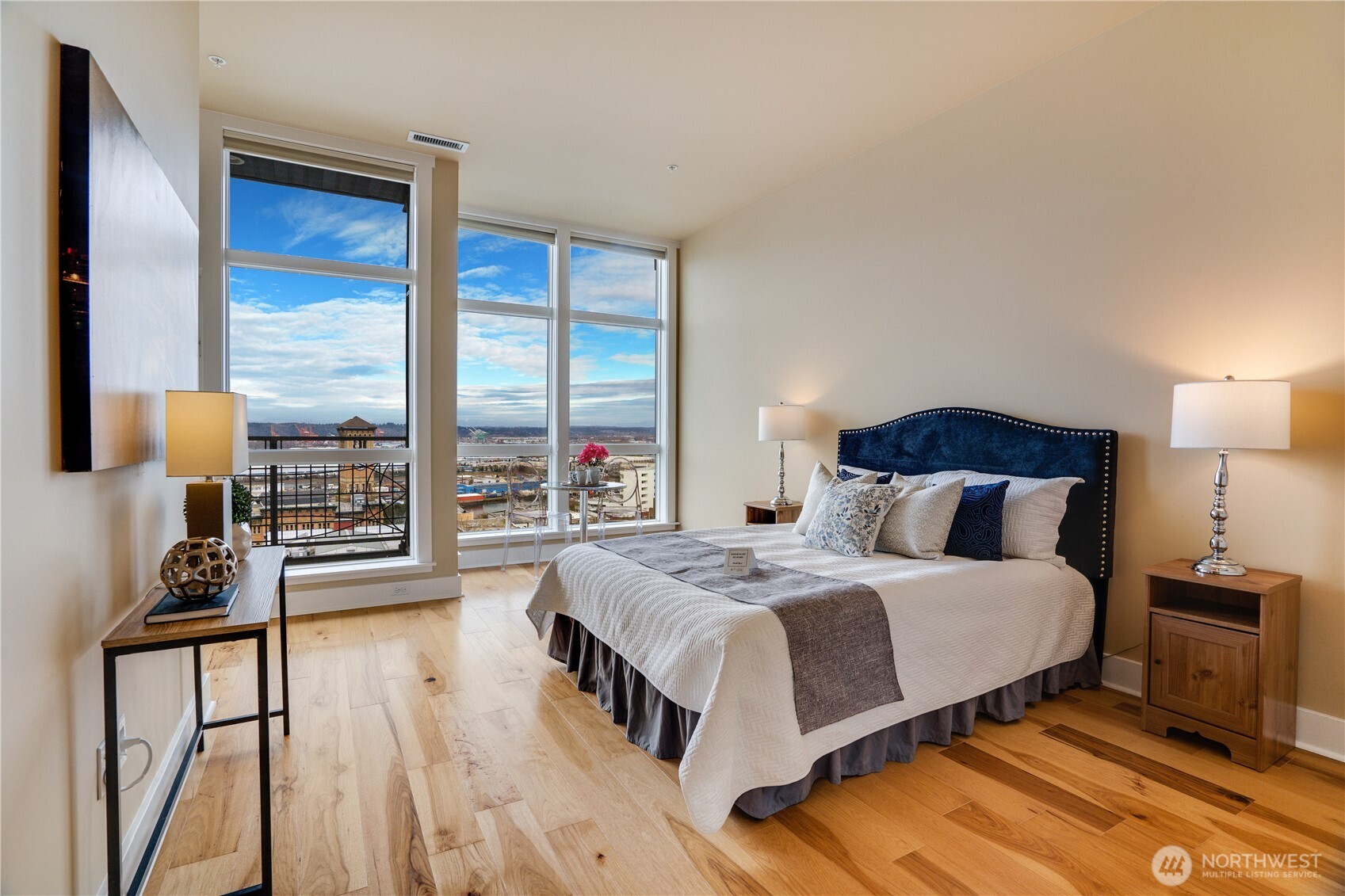 708 Market Street, Unit 705 Tacoma, WA 98402 - Photo 12 of 38 a bedroom with a bed a large window and wooden floor