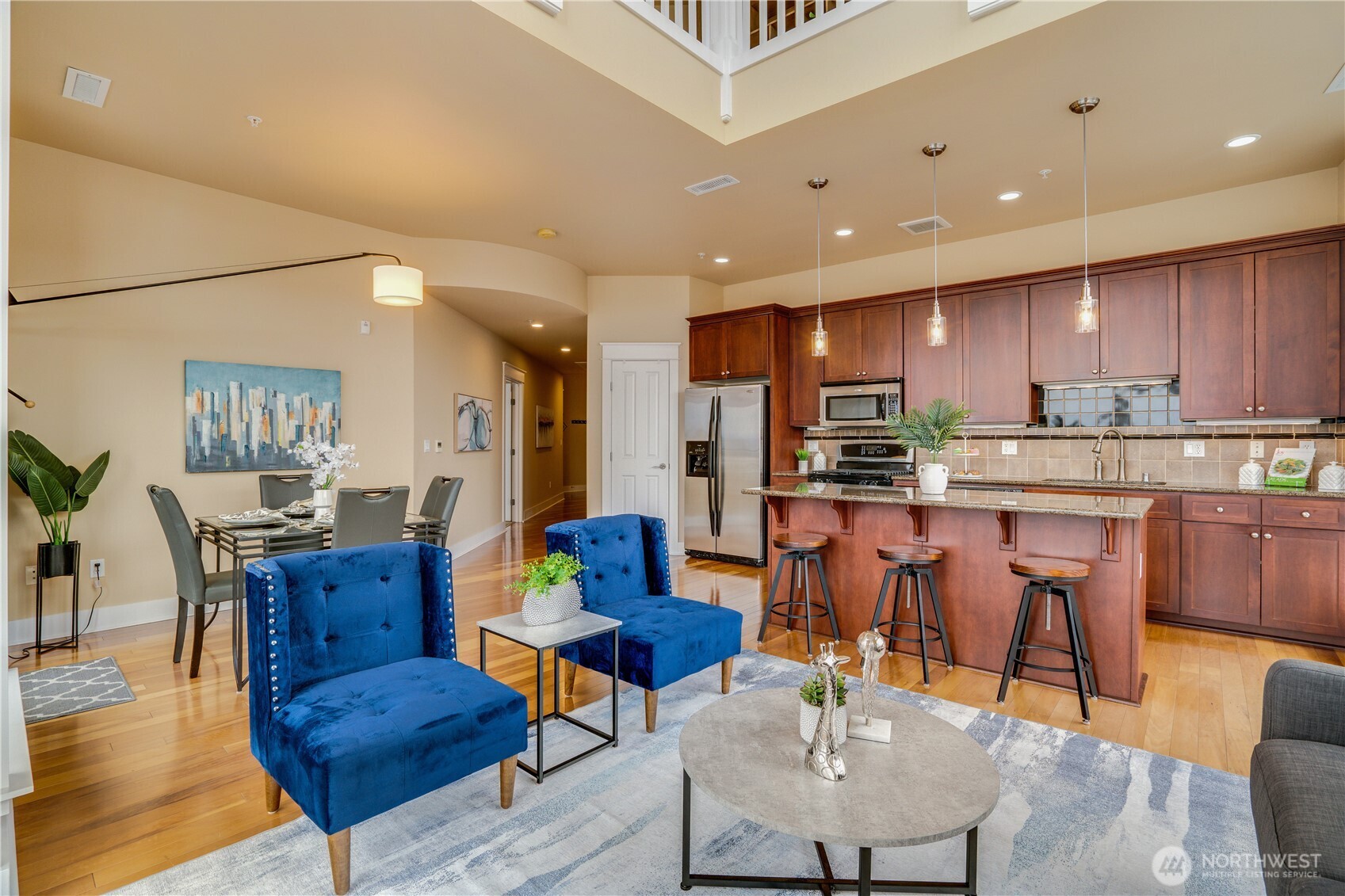 708 Market Street, Unit 705 Tacoma, WA 98402 - Photo 6 of 38 a living room with stainless steel appliances furniture a dining table and kitchen view