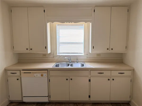 a kitchen with white cabinets and white appliances