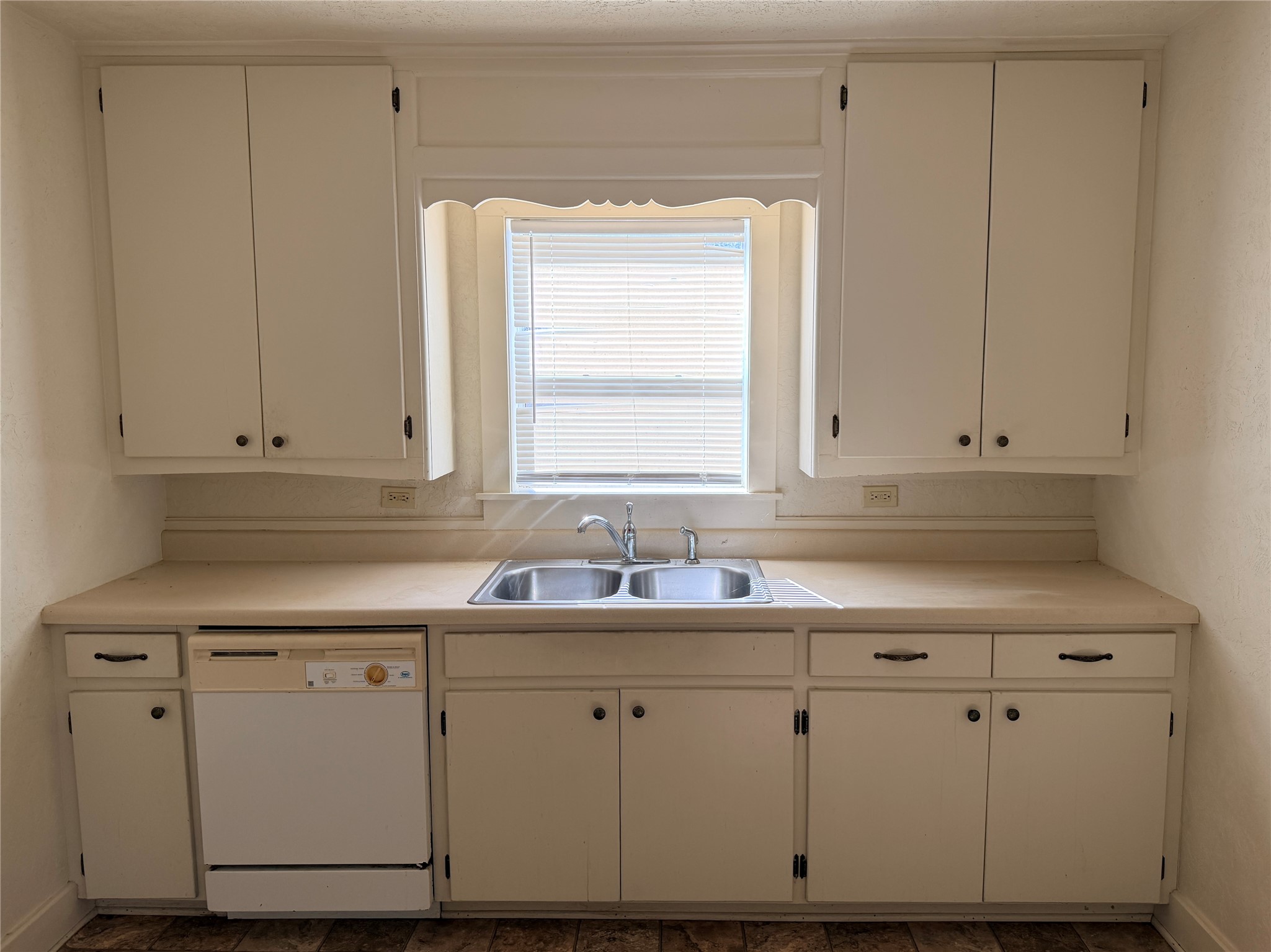 502 West Third Street Brenham, TX 77833 - Photo 5 of 10 a kitchen with white cabinets and white appliances