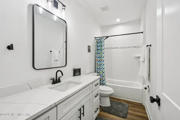 a bathroom with a sink toilet and shower