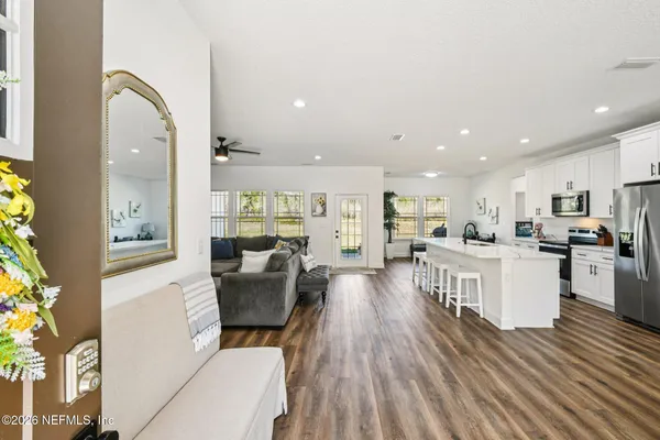 a living room with furniture and a flat screen tv