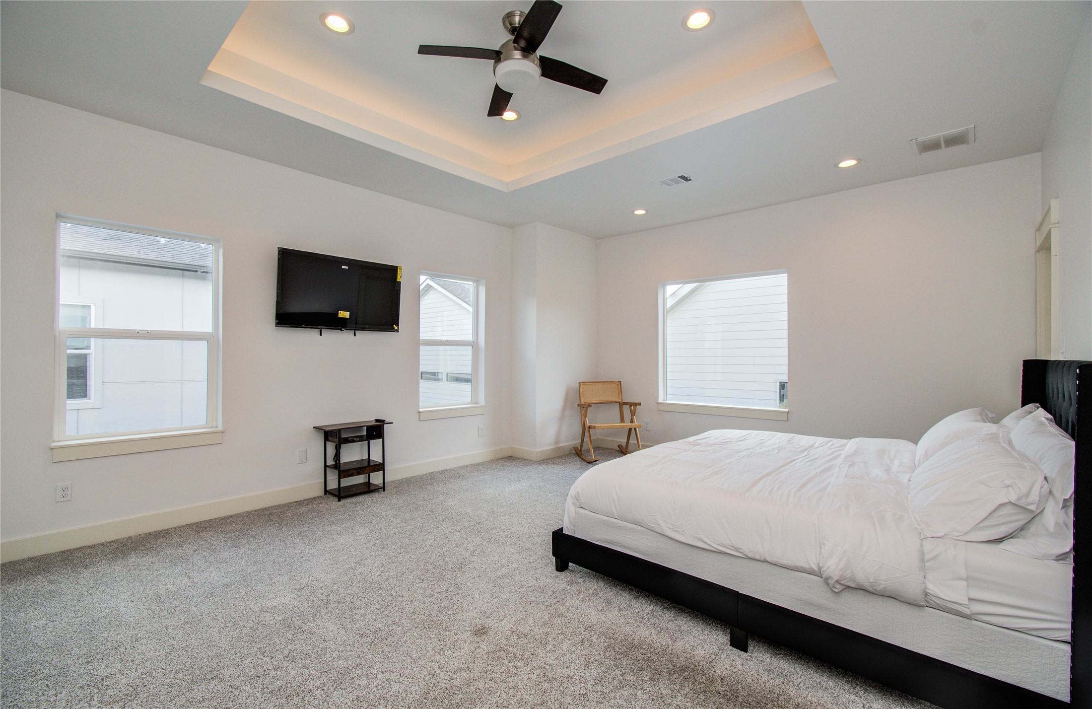 4311 Marina Street Houston, TX 77007 - Photo 29 of 42 a bedroom with a bed a flat screen tv and couches