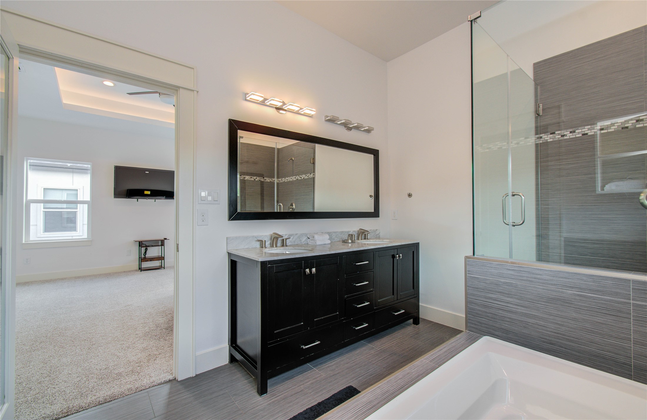 4311 Marina Street Houston, TX 77007 - Photo 31 of 42 a bathroom with a sink a mirror and a shower