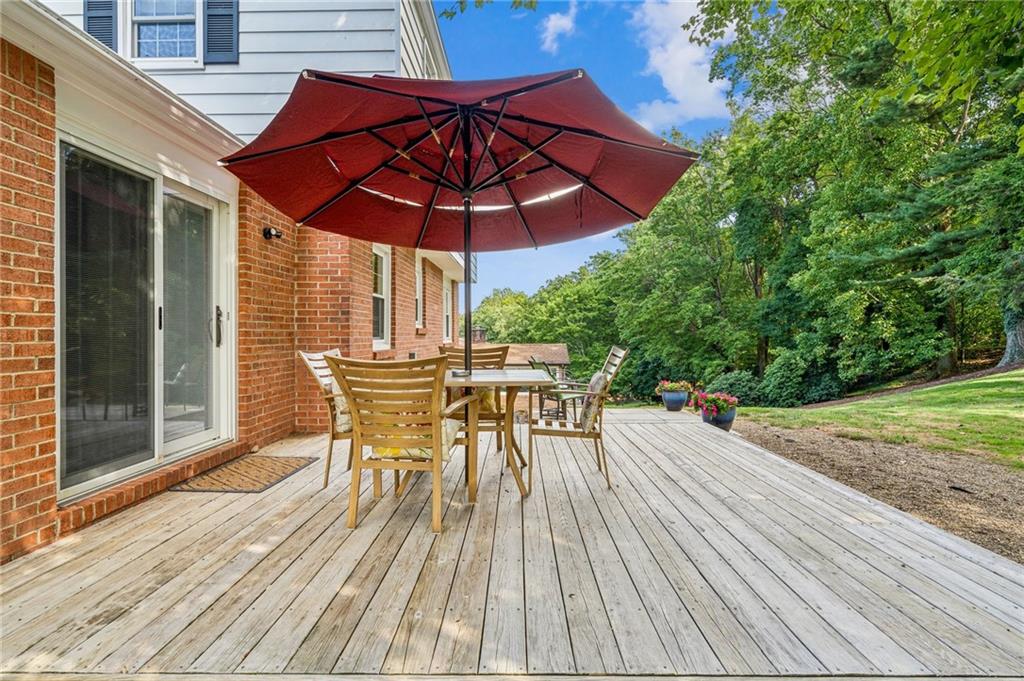106 Cameron Drive Irwin, PA 15642 - Photo 23 of 27 a view of a patio with table and chairs under an umbrella with wooden floor