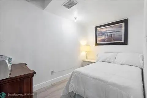 a bedroom with a bed and a lamp on table