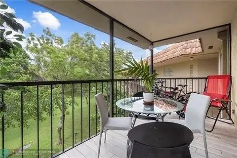 a dining room with furniture and a floor to ceiling window