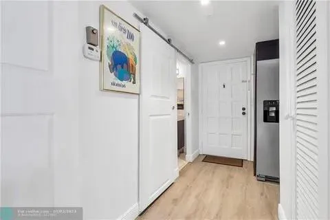 a view of a hallway with wooden floor