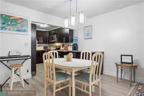 a view of a dining room with furniture and a chandelier