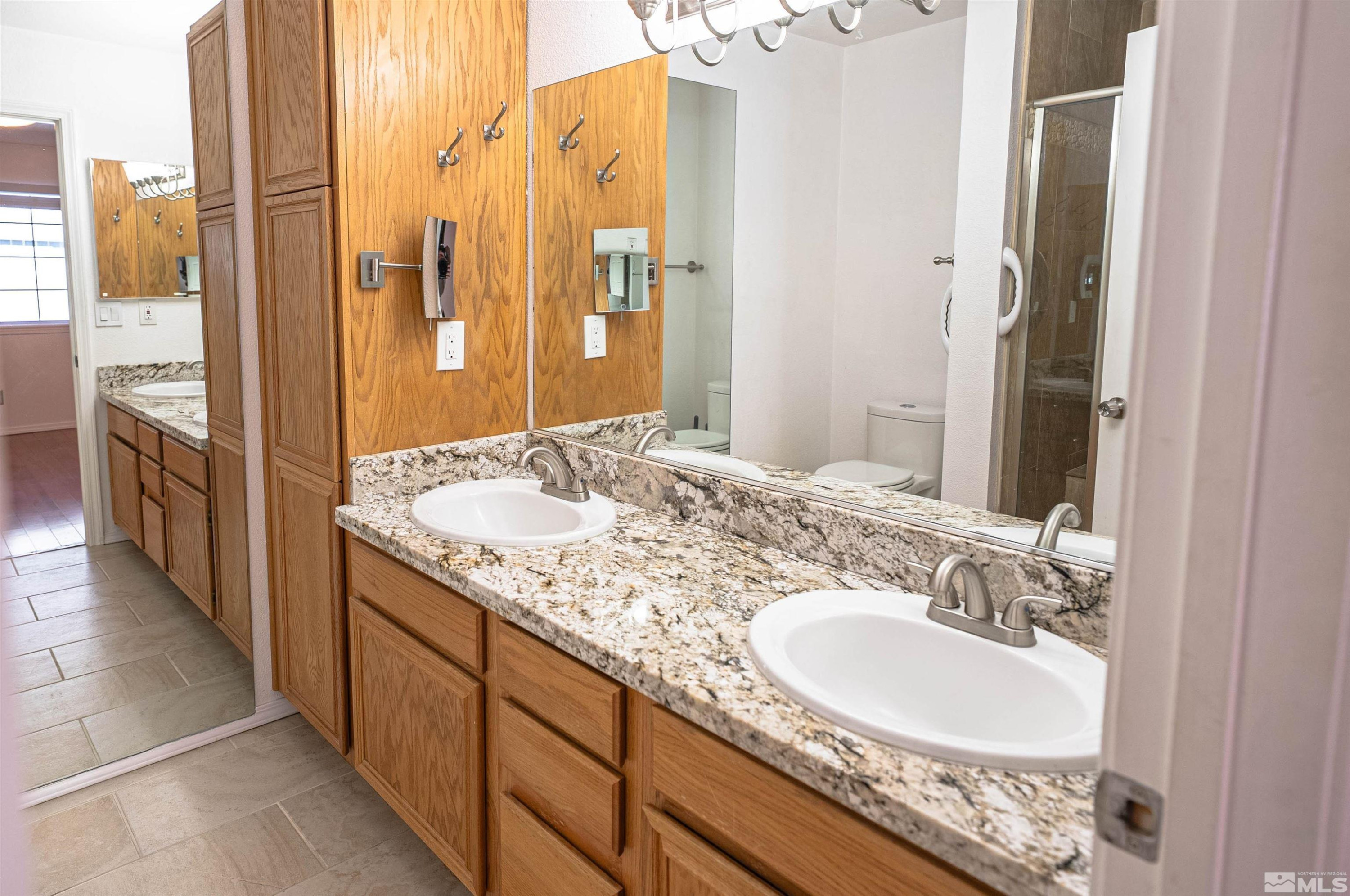 980 Ridgeview Drive Carson City, NV 89705 - Photo 13 of 18 a bathroom with a granite countertop double vanity sink and a mirror