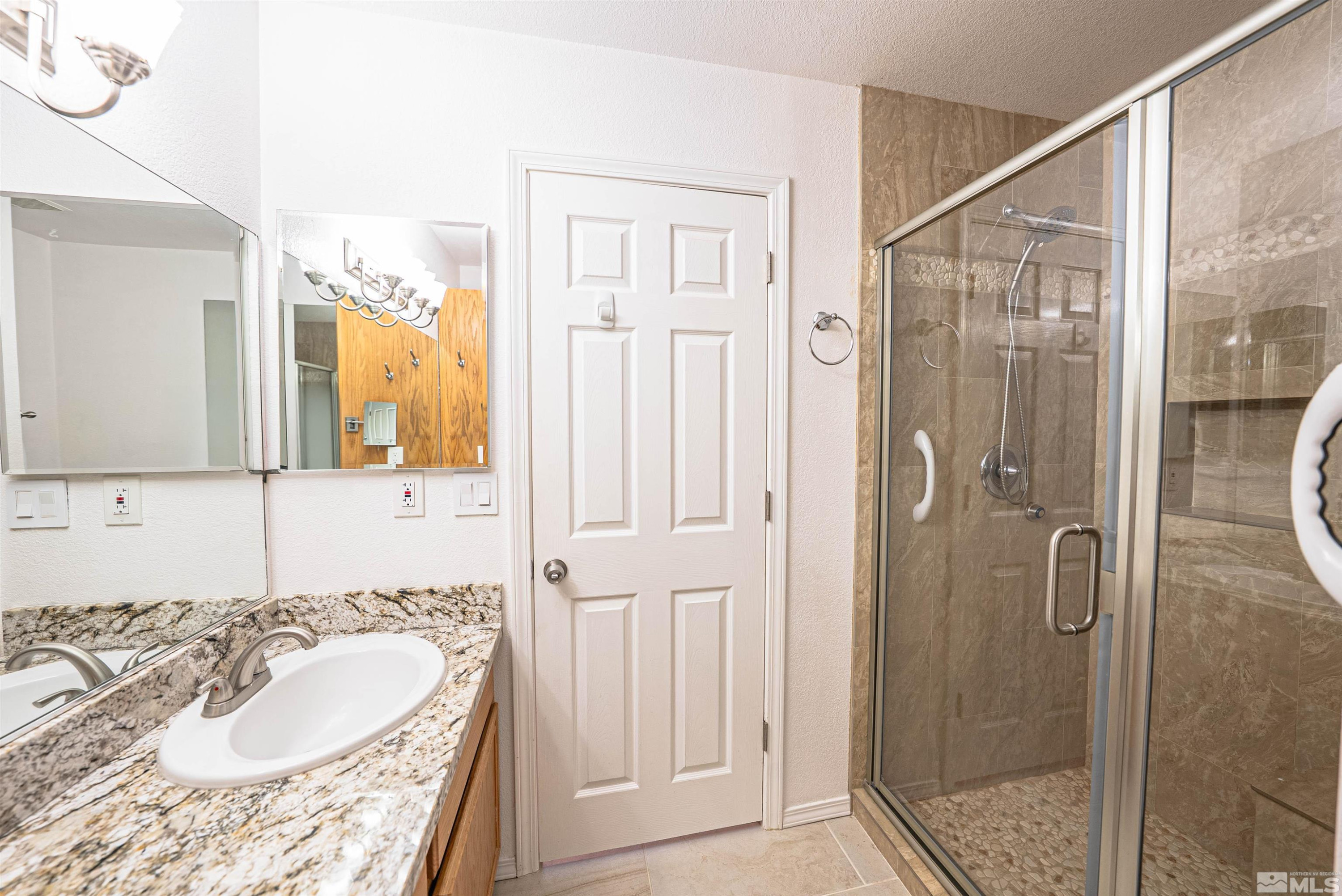 980 Ridgeview Drive Carson City, NV 89705 - Photo 14 of 18 a bathroom with a granite countertop shower sink and mirror