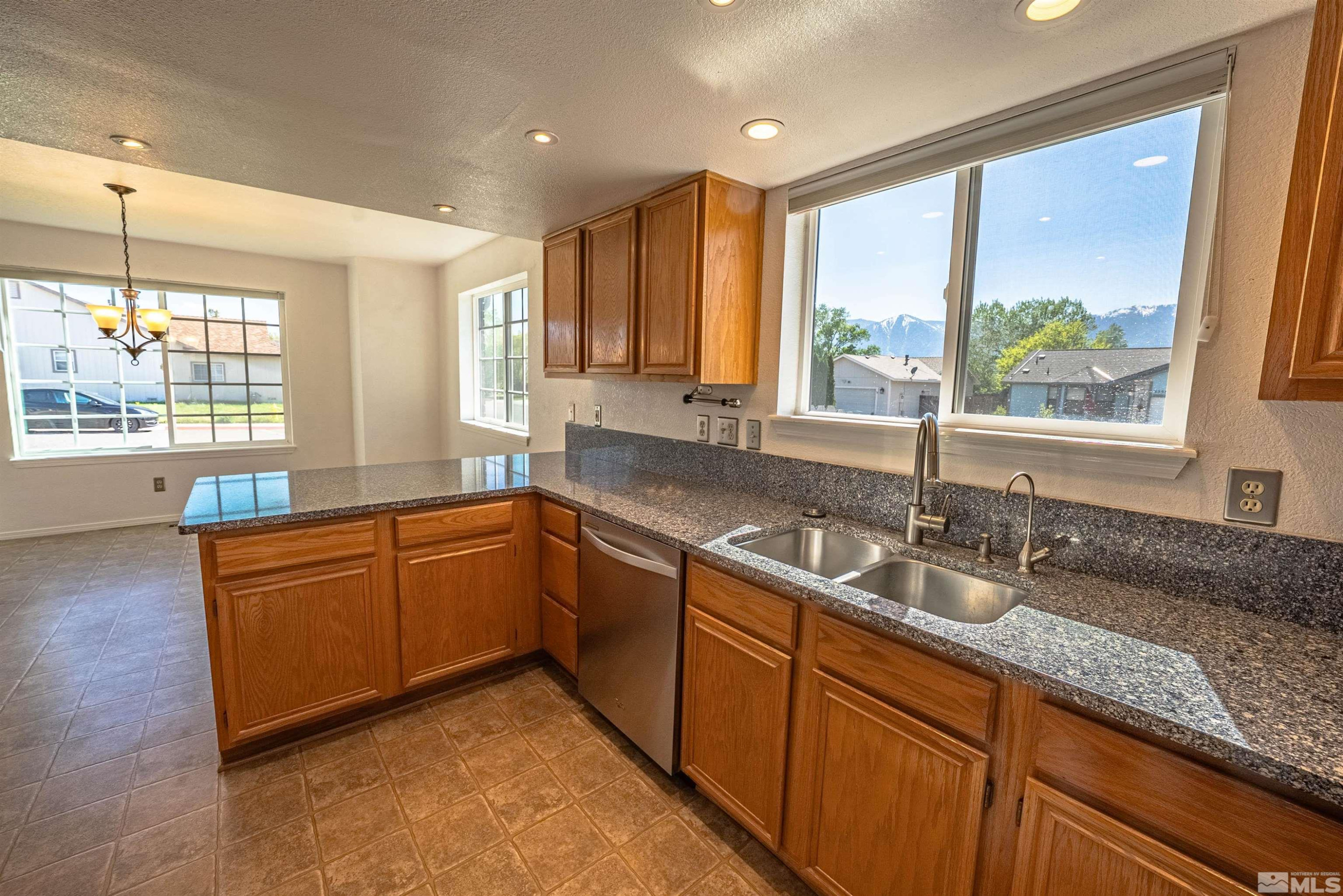 980 Ridgeview Drive Carson City, NV 89705 - Photo 2 of 18 a kitchen with granite countertop a sink a counter space appliances and cabinets