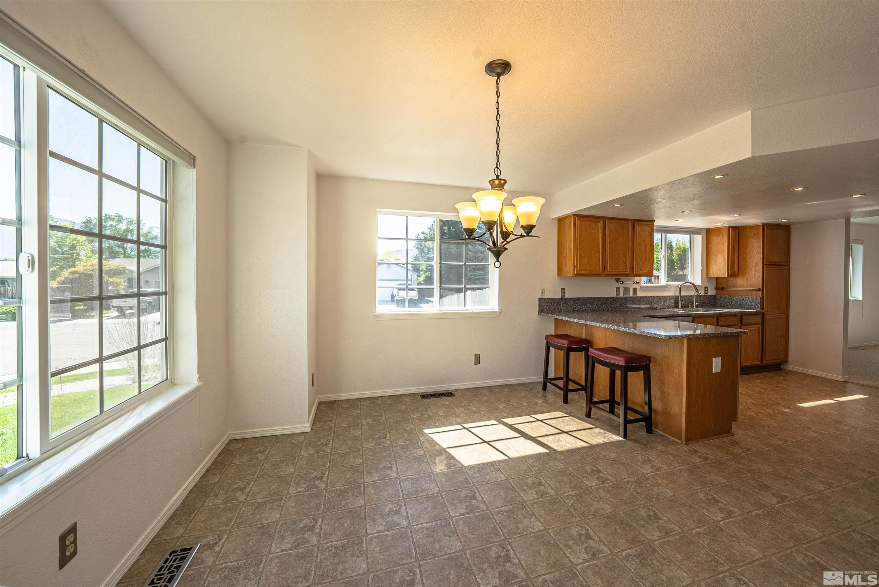 980 Ridgeview Drive Carson City, NV 89705 - Photo 3 of 18 a kitchen with kitchen island granite countertop a stove and a window